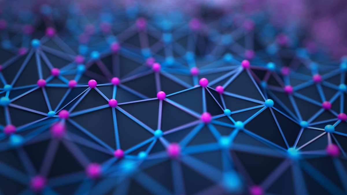 Abstract visualization of a 3D network, showcasing interconnected nodes with glowing pink and blue spheres connected by thin lines on a dark gradient background, symbolizing communication and technology.